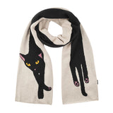 A knitted scarf in beige and black, featuring a large black cat design on one side and a black hand with pink paw pads on the other, shown against a white background.