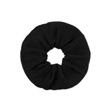 A black rib fabric hair scrunchie centered on a white background.