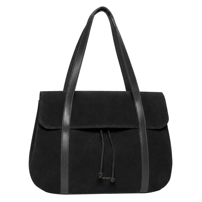 A black suede tote bag with black leather shoulder straps and a drawstring closure, photographed against a clean white background.