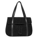 A black suede tote bag with black leather shoulder straps and a drawstring closure, photographed against a clean white background.
