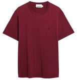 Maroon t-shirt with a small logo on a white background
